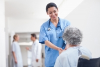 nurse helping older patient 